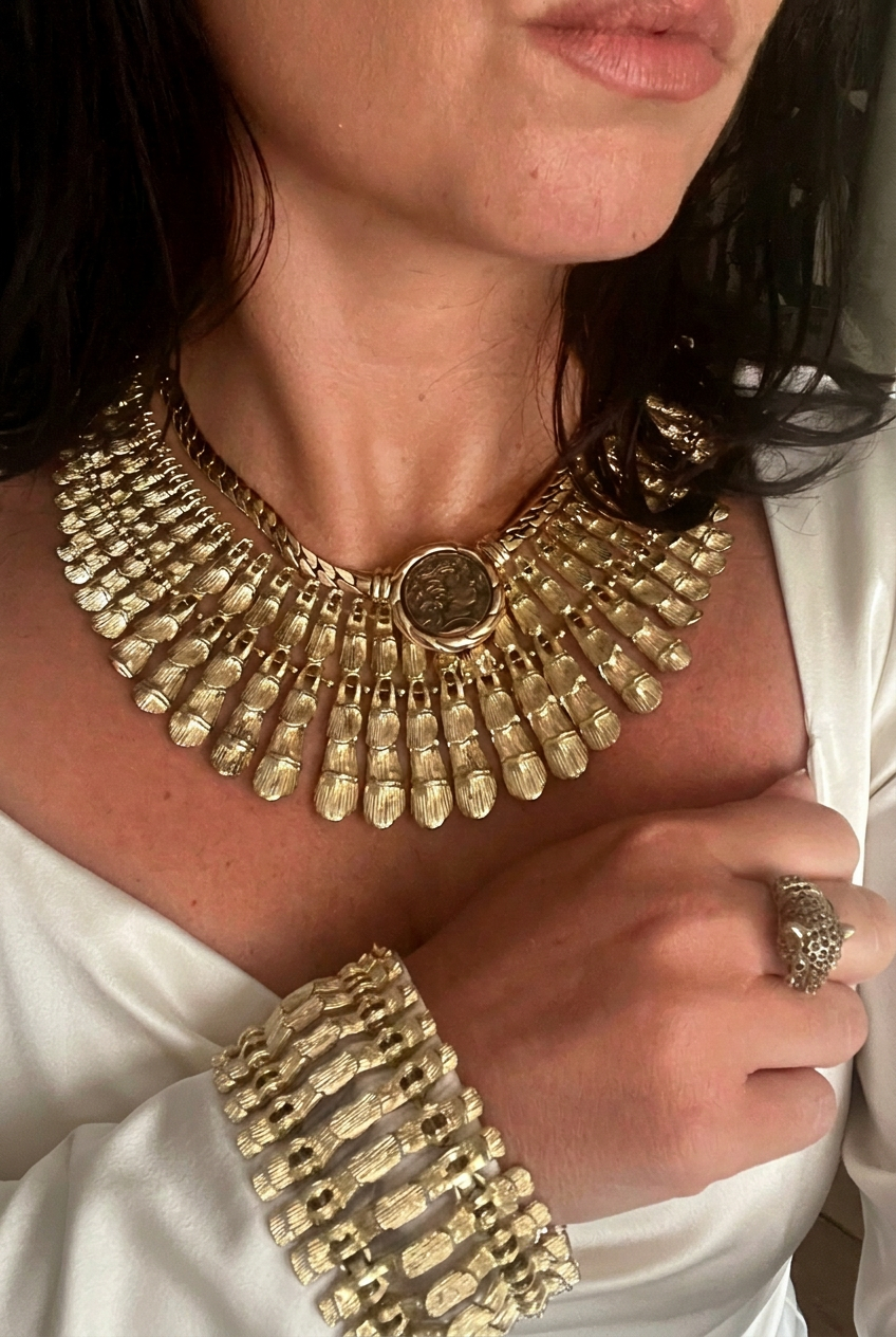 AI-styled editorial image of BSK Cleopatra necklace and bracelet worn with ivory silk
