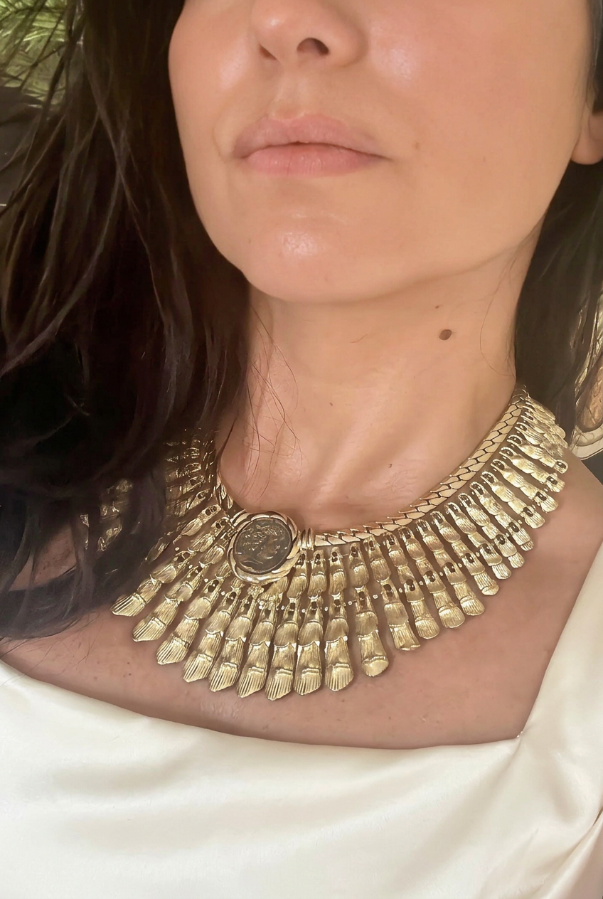 AI-styled editorial close-up of BSK Cleopatra necklace with ivory silk neckline