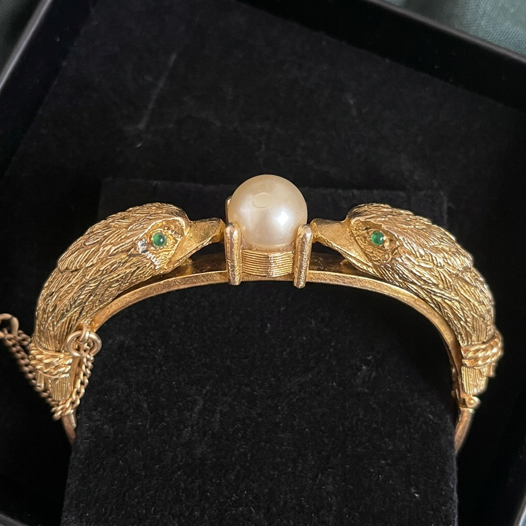 AI-styled close-up of Castlecliff double-swan bangle and central pearl detail